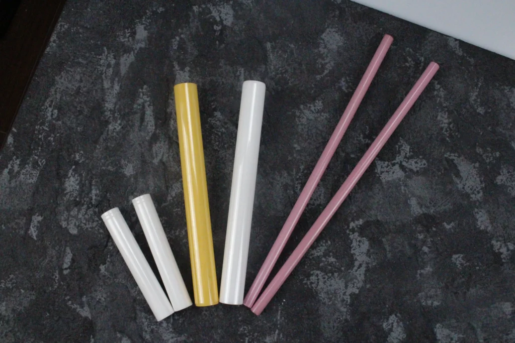 Assorted colored zirconia ceramic rods with smooth surfaces, used for high-durability industrial and medical applications.