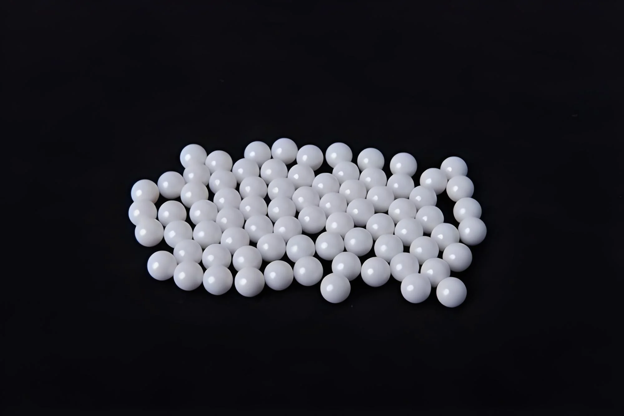 Bulk zirconia ceramic balls showing uniform size and precision finish